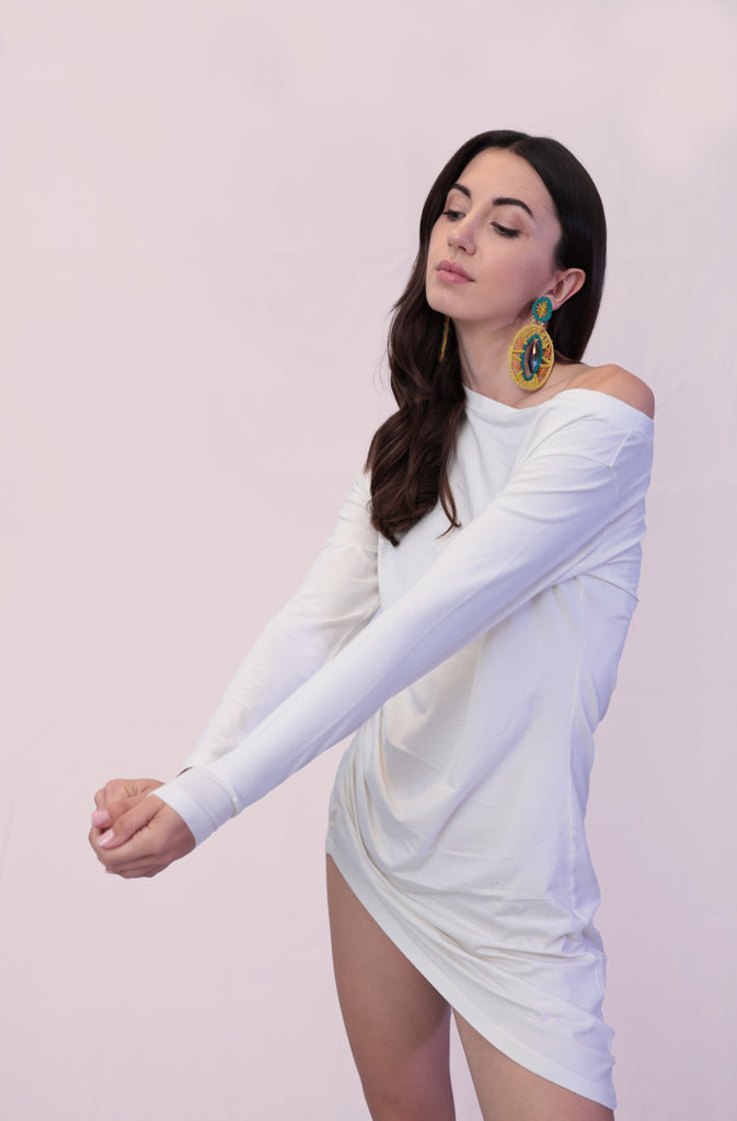 Solda TunicTopsThis sleek, long-sleeve tunic top features an off-the-shoulder design that accentuates your neckline and flatters the shoulders. The asymmetric bottom hem adds a touGlobalistinaSolda TunicGlobalistina