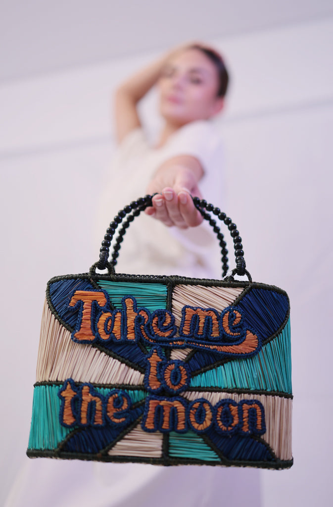 Take Me To The Moon HandbagHard Shaped BagQuirky bag with welded structure and 'Take me to the Moon' statement across the front. Inner lining in cotton fabric with a cord closing system to ensure your belongGlobalistinaMoon HandbagGlobalistina