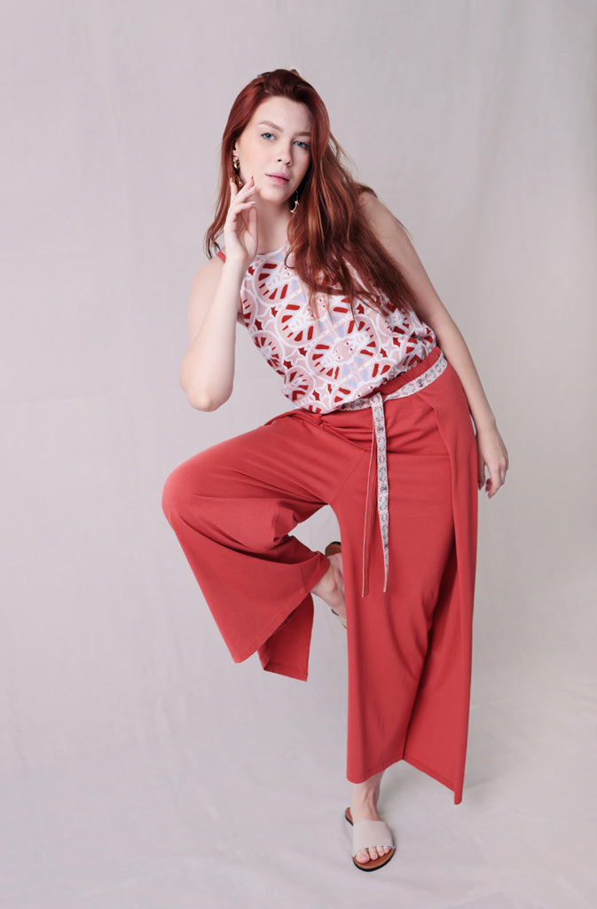 Kynuna Flare TrousersTrousersComfy brick red palazzo style culotte trousers with a dropped crotch. Ankle length with a wrap/cape design that accentuates the A-shape of the trousers and gently coGlobalistinaKynuna Flare TrousersGlobalistina