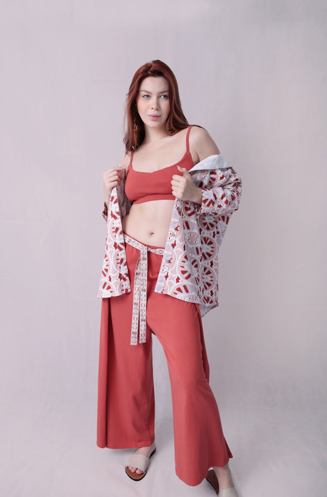 Kynuna Flare TrousersTrousersComfy brick red palazzo style culotte trousers with a dropped crotch. Ankle length with a wrap/cape design that accentuates the A-shape of the trousers and gently coGlobalistinaKynuna Flare TrousersGlobalistina