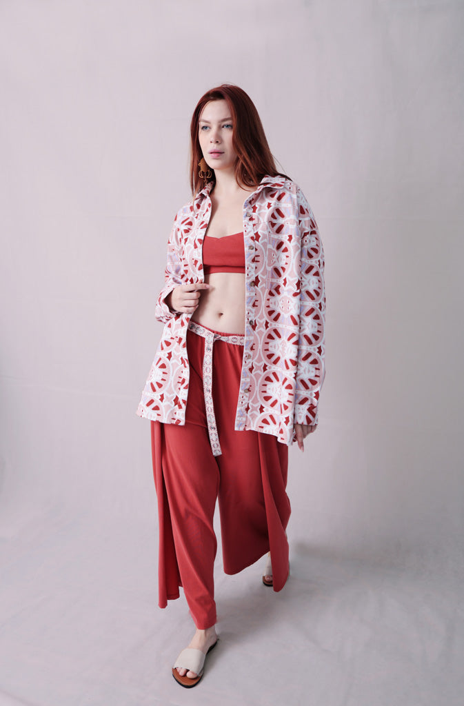 Kynuna Flare TrousersTrousersComfy brick red palazzo style culotte trousers with a dropped crotch. Ankle length with a wrap/cape design that accentuates the A-shape of the trousers and gently coGlobalistinaKynuna Flare TrousersGlobalistina