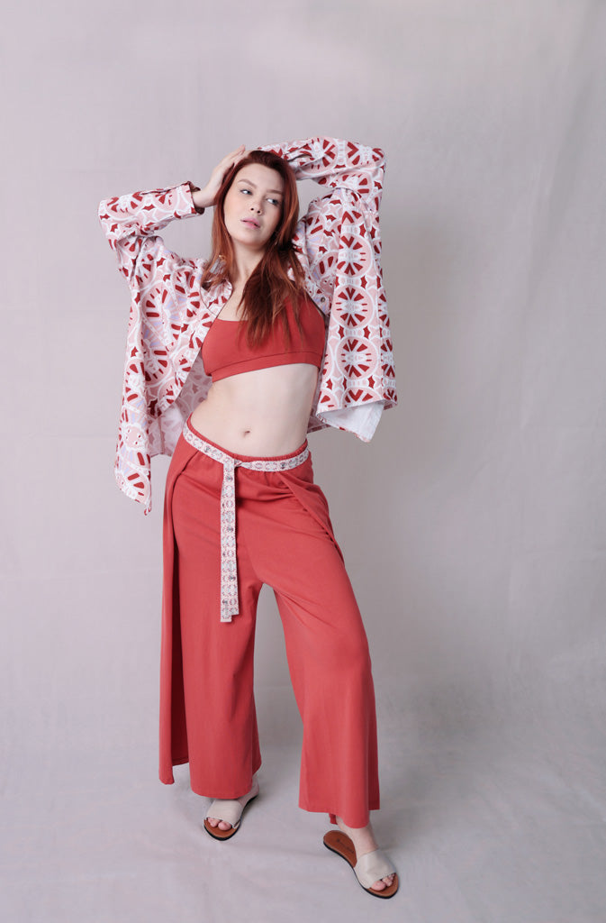 Kynuna Flare TrousersTrousersComfy brick red palazzo style culotte trousers with a dropped crotch. Ankle length with a wrap/cape design that accentuates the A-shape of the trousers and gently coGlobalistinaKynuna Flare TrousersGlobalistina