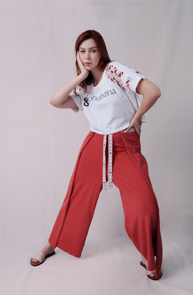 Kynuna Flare TrousersTrousersComfy brick red palazzo style culotte trousers with a dropped crotch. Ankle length with a wrap/cape design that accentuates the A-shape of the trousers and gently coGlobalistinaKynuna Flare TrousersGlobalistina