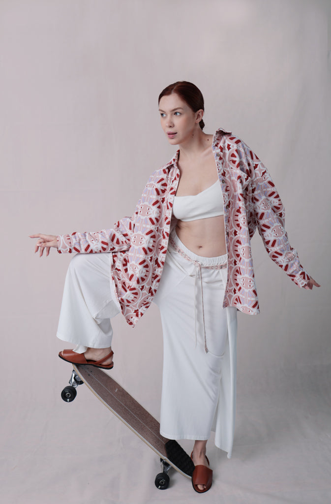 Kynuna Flare TrousersTrousersComfy brick red palazzo style culotte trousers with a dropped crotch. Ankle length with a wrap/cape design that accentuates the A-shape of the trousers and gently coGlobalistinaKynuna Flare TrousersGlobalistina