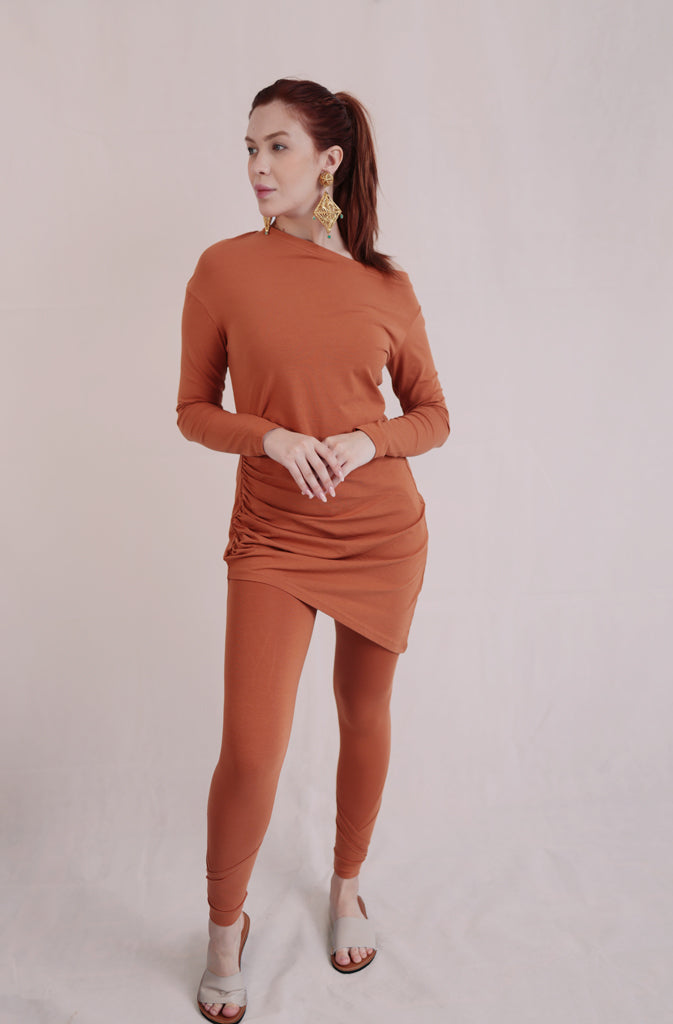 Solda TunicTopsThis sleek, long-sleeve tunic top features an off-the-shoulder design that accentuates your neckline and flatters the shoulders. The asymmetric bottom hem adds a touGlobalistinaSolda TunicGlobalistina