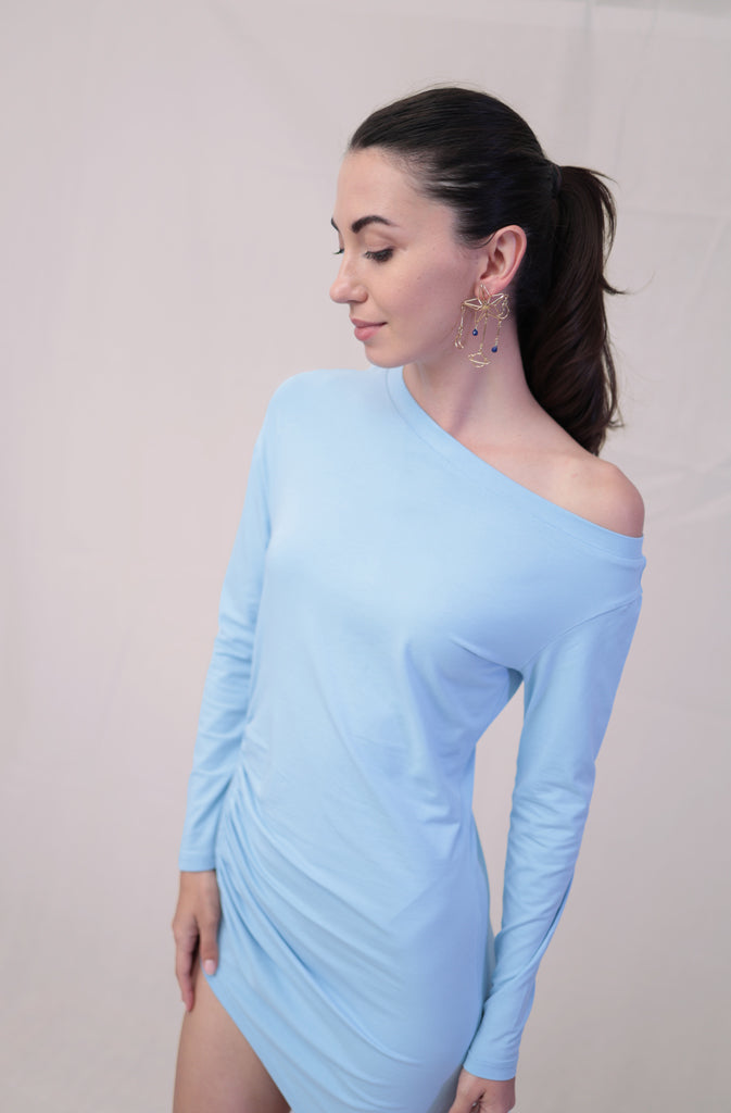 Solda TunicTopsThis sleek, long-sleeve tunic top features an off-the-shoulder design that accentuates your neckline and flatters the shoulders. The asymmetric bottom hem adds a touGlobalistinaSolda TunicGlobalistina